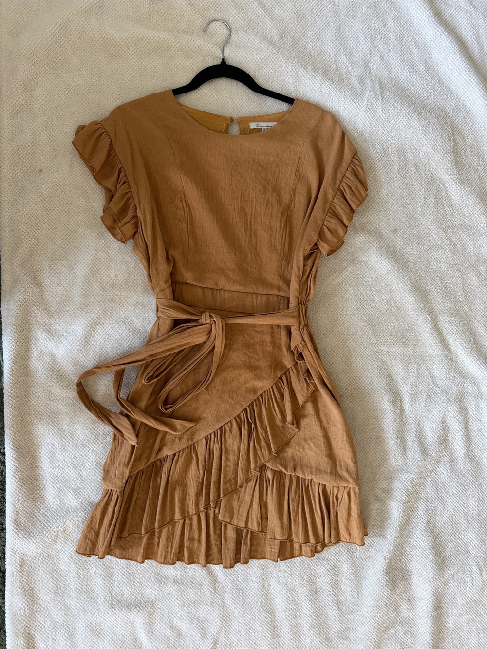 the clothing company Ruffle Wrap Mini Dress in Tan with side zipper